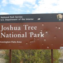 Shot up Joshua Tree NP sign at North park bounday, Vermiculate Mine Road, 02/02/2016