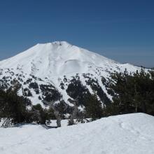 Mount Bachelor from Tumalo Mountain, showing Summit Express Chair on left face, and distance to actual summit on right 