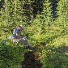 Good water supply at Camp - K7MAS pumping water through filter - Photo KG7EJT