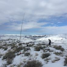 There are 2 metal rods at the summit to strap mast to.