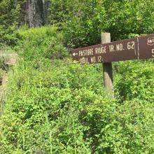 Pasture Ridge Trail Sign from trail junction behind barn.