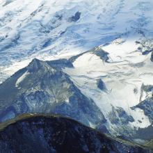 Close Up shot of Mt Ruth (mostly bare peak forward) and Steamboat Prow (snowy peak on right).  Mtn Climbers Camp Shurman is behind the Prow.  