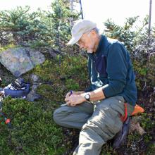 KR7W using straight key for CW.  Rig is KX3, Antenna is Dan's 44 ft Doublet + Balun, mast is 21 ft carbon fishing pole strapped to tree (above kr7w's head).  Kenwood D72 for 2 meter comms + APRS spotting.