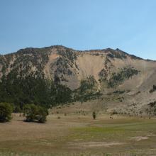 The summit is the high point in the middle of the ridge. Note lookout tower.